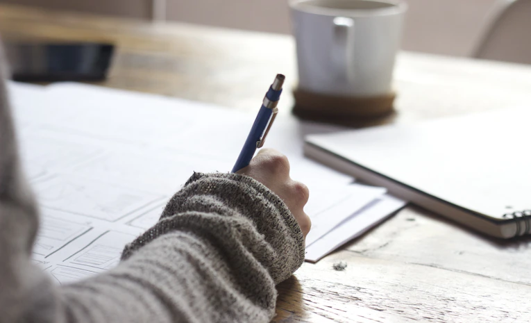 Student sketching career planning notes on a desk, representing how to choose a career path