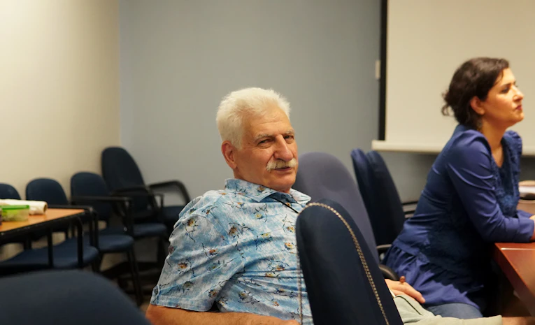Older adults in a learning setting, representing adult education