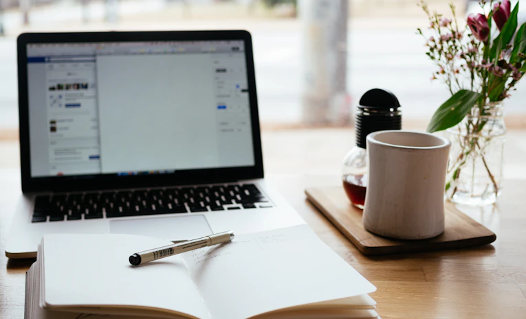 Laptop and notebook, representing free online courses