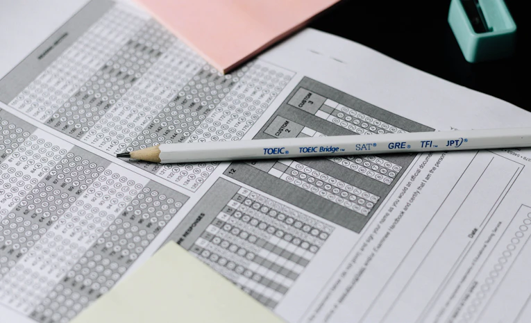 Pencil resting on a multiple choice answer sheet, representing appealing exam results