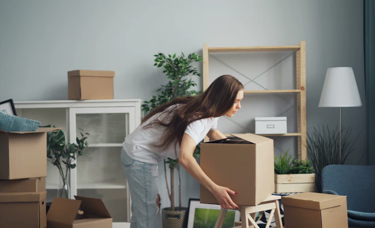 Person moving boxes into a room, representing preparing for university
