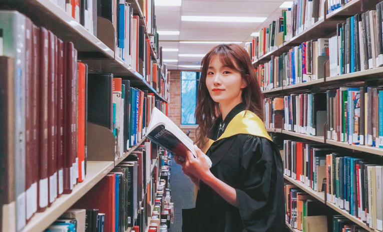 Graduate student in a library, representing master's degree study