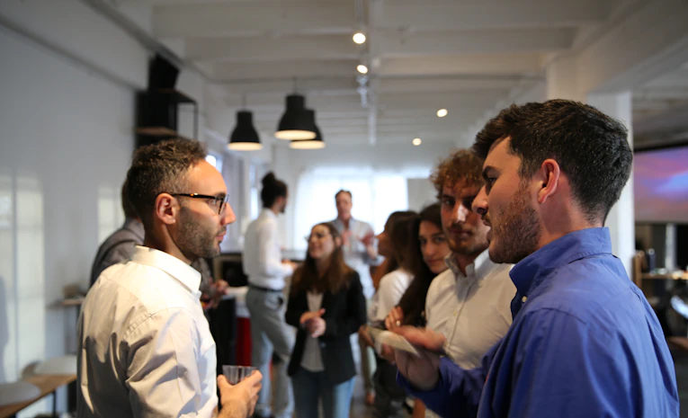 Group of professionals talking at a networking event, representing networking tips for students