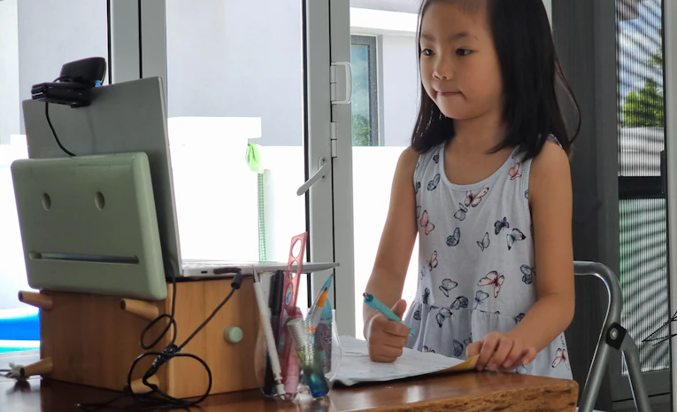 Child learning on a computer at home, representing remote learning