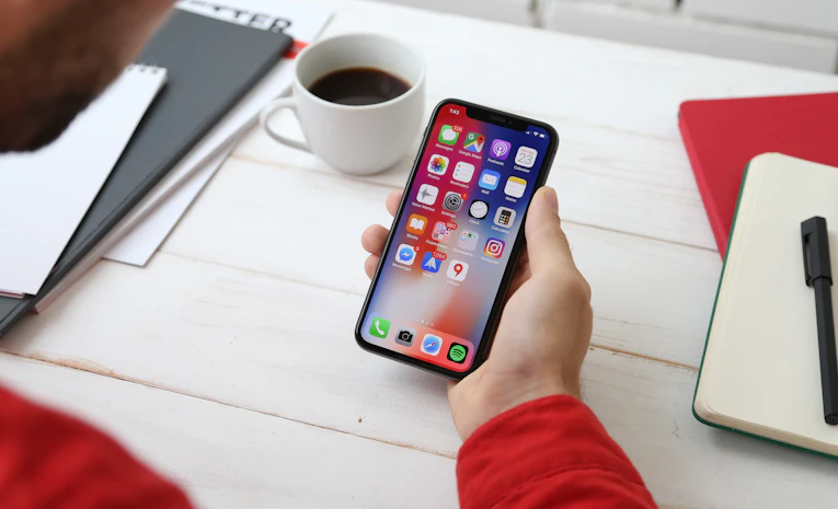 Person holding a smartphone, representing revision apps for GCSE and A Level