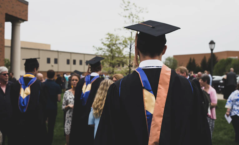 Graduate in academic gown, representing scholarships and funded study in the UK