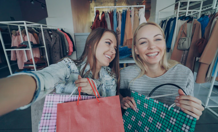 Woman smiling with shopping bags, representing student discounts