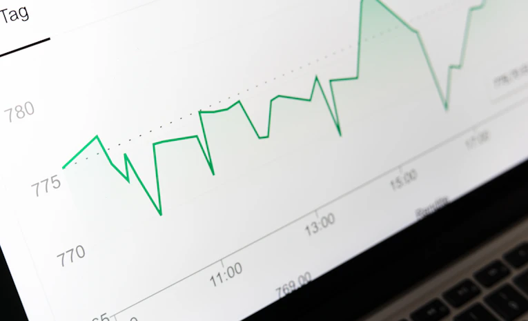 Stock market chart displayed on a laptop screen, representing student loan interest rates