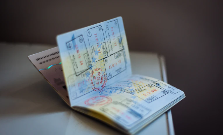 Open passport with travel stamps, representing studying abroad
