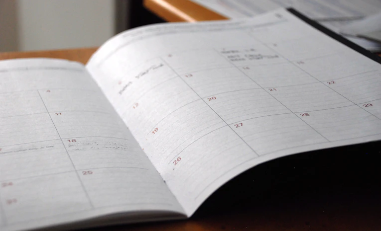 Open monthly planner on a desk, representing time management for students