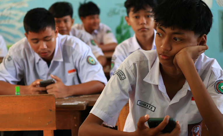 Students checking their phones, representing UCAS Clearing on results day